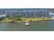 Waterfront condo building with dock, lush green lawns, and beautifully maintained landscaping at 1847 Shore S Dr # 507, South Pasadena, FL 33707