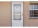 Front door to unit 507, adjacent to a window on the exterior hallway of the tan condo complex at 1847 Shore S Dr # 507, South Pasadena, FL 33707