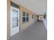 Exterior hallway featuring access to unit 507, windows, and a white railing in this tan condo complex at 1847 Shore S Dr # 507, South Pasadena, FL 33707