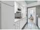Bright kitchen featuring white cabinets, microwave and gas range in this condo unit at 1847 Shore S Dr # 507, South Pasadena, FL 33707