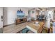 Living room featuring wood floors and beach decor, that opens to dining room in condo unit at 1847 Shore S Dr # 507, South Pasadena, FL 33707