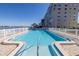 Large community pool features sparkling blue water and stunning waterfront views on a sunny day at 1847 Shore S Dr # 507, South Pasadena, FL 33707