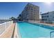 A community pool is surrounded by manicured landscaping and offers direct waterfront access at 1847 Shore S Dr # 507, South Pasadena, FL 33707