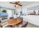 Relaxing sunroom featuring water views, a ceiling fan, and comfortable furniture at 1847 Shore S Dr # 507, South Pasadena, FL 33707
