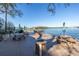 Enjoy outdoor dining by the water with picnic tables and umbrellas, featuring a cozy fire pit at 1847 Shore S Dr # 507, South Pasadena, FL 33707