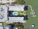 Aerial view of condo building showcasing its pool, landscaping, parking and private boat dock at 19531 Gulf Blvd # 210, Indian Shores, FL 33785