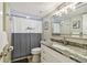 Cozy bathroom featuring a shower with tub, granite counters, and decorative mirror at 19531 Gulf Blvd # 210, Indian Shores, FL 33785