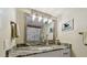 Well-lit bathroom featuring a granite countertop, decorative mirror, and shower with a tub at 19531 Gulf Blvd # 210, Indian Shores, FL 33785