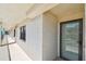 Neutral hallway showing the entrance to the unit with a window on the side at 19531 Gulf Blvd # 210, Indian Shores, FL 33785