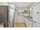 Bright kitchen with a stainless steel refrigerator and a view of outside at 19531 Gulf Blvd # 210, Indian Shores, FL 33785