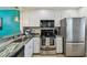 Modern kitchen featuring stainless steel appliances and granite countertops at 19531 Gulf Blvd # 210, Indian Shores, FL 33785