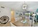 Bright and airy living and dining area with modern decor and sliding door access to a balcony at 19531 Gulf Blvd # 210, Indian Shores, FL 33785