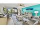 Cozy living room featuring a ceiling fan, comfortable furniture, decor, and a balcony view at 19531 Gulf Blvd # 210, Indian Shores, FL 33785