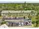 Aerial front view of condo building and parking lot surrounded by trees at 2005 Greenbriar Blvd # 7, Clearwater, FL 33763