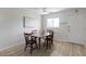 Dining area with wood floors, ceiling fan, lots of light, and table for four at 2005 Greenbriar Blvd # 7, Clearwater, FL 33763