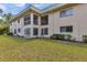 Back exterior view of condo building and its green grass lawn at 2005 Greenbriar Blvd # 7, Clearwater, FL 33763