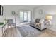 Bright living room with stylish furniture, rug, and sliding door leading to the outdoors at 2005 Greenbriar Blvd # 7, Clearwater, FL 33763