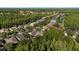 An aerial perspective highlights the tranquil neighborhood featuring well-maintained homes surrounded by mature trees and a serene pond at 20403 Walnut Grove Ln, Tampa, FL 33647