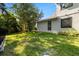 Spacious backyard with lush green grass and mature trees, great for outdoor activities at 20403 Walnut Grove Ln, Tampa, FL 33647