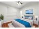 Serene bedroom featuring hardwood floors, a ceiling fan, and ample natural light at 20403 Walnut Grove Ln, Tampa, FL 33647