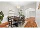 Dining area with hardwood floors, wainscotting, view into the hallway, and a modern chandelier at 20403 Walnut Grove Ln, Tampa, FL 33647