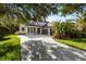 Elegant home with a three-car garage, beautiful landscaping and a curved paved walkway at 20403 Walnut Grove Ln, Tampa, FL 33647