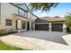Beautiful two-story home with a three-car garage, elegant entrance and paver driveway at 20403 Walnut Grove Ln, Tampa, FL 33647