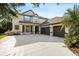 Two story home with a large driveway, three-car garage, and manicured landscaping at 20403 Walnut Grove Ln, Tampa, FL 33647