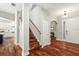 A foyer featuring wood stairs, hardwood floors and an entry door with decorative glass at 20403 Walnut Grove Ln, Tampa, FL 33647