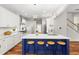 Bright, modern kitchen with an island, white cabinetry, stainless steel appliances and hardwood flooring at 20403 Walnut Grove Ln, Tampa, FL 33647