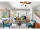 Comfortable living room with hardwood flooring, ceiling fan, furniture, and sliding glass doors to outside at 20403 Walnut Grove Ln, Tampa, FL 33647