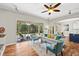 Living room with ceiling fan, hardwood floors and large sliding glass doors to outside at 20403 Walnut Grove Ln, Tampa, FL 33647