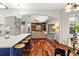 View of the open kitchen and living space with hardwood floors and lots of natural light at 20403 Walnut Grove Ln, Tampa, FL 33647