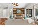 Beautiful living room features a custom wood accent wall with modern shelving and sliding doors to patio at 20403 Walnut Grove Ln, Tampa, FL 33647