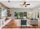 Open living room with hardwood flooring, a ceiling fan, and sliding glass doors to outside at 20403 Walnut Grove Ln, Tampa, FL 33647