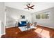 Cozy living room with hardwood floors, comfortable seating, and a ceiling fan at 20403 Walnut Grove Ln, Tampa, FL 33647
