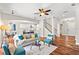 Spacious living room boasts hardwood floors, modern ceiling fan, and open floor plan to kitchen at 20403 Walnut Grove Ln, Tampa, FL 33647