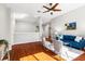Bright living room featuring hardwood floors, a ceiling fan, and modern furniture at 20403 Walnut Grove Ln, Tampa, FL 33647