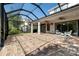 Brick-paved, screened lanai features ceiling fans, access doors, and a relaxing outdoor area for entertaining at 20403 Walnut Grove Ln, Tampa, FL 33647