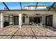 Spacious, screened-in lanai featuring brick pavers, ceiling fans, and an inviting outdoor space for relaxation at 20403 Walnut Grove Ln, Tampa, FL 33647