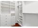 Bright, spacious walk-in closet with custom shelving and drawer units for optimal organization and storage at 20403 Walnut Grove Ln, Tampa, FL 33647