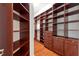 Large walk-in closet with shelves, wooden drawers, hardwood floor and window at 20403 Walnut Grove Ln, Tampa, FL 33647