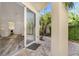 Covered back patio with brick pavers and tropical foliage with access to home at 2410 W North A St # 2, Tampa, FL 33609