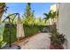 Backyard featuring privacy fence, brick pavers, and lush tropical landscaping at 2410 W North A St # 2, Tampa, FL 33609