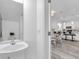Clean bathroom with white pedestal sink and access to the dining and kitchen areas at 2410 W North A St # 2, Tampa, FL 33609