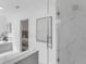 This bathroom has a large shower with marble-look tile, a glass door, and a view into the bedroom at 2410 W North A St # 2, Tampa, FL 33609