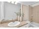 Bathroom featuring a granite vanity, decorative vases, a tiled shower-tub, and a mirror at 2410 W North A St # 2, Tampa, FL 33609