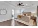 Bedroom showcases wood floors, ceiling fan, tray ceiling, ensuite access and natural light at 2410 W North A St # 2, Tampa, FL 33609