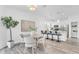 Open-concept dining area near kitchen with hardwood floors, modern lighting, barstool seating and stainless appliances at 2410 W North A St # 2, Tampa, FL 33609