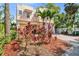 Exterior elevation with a two-car garage, mature landscaping, and brick-paved driveway at 2410 W North A St # 2, Tampa, FL 33609